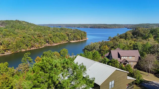 an aerial view of a house with a lake view