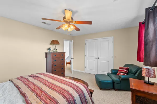 a bedroom with a bed and a chandelier