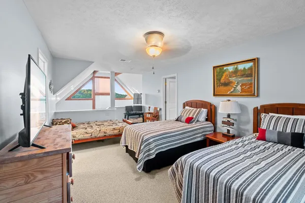 a bedroom with two beds and a window