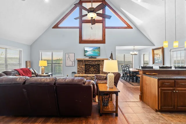 a living room with furniture a fireplace and a chandelier