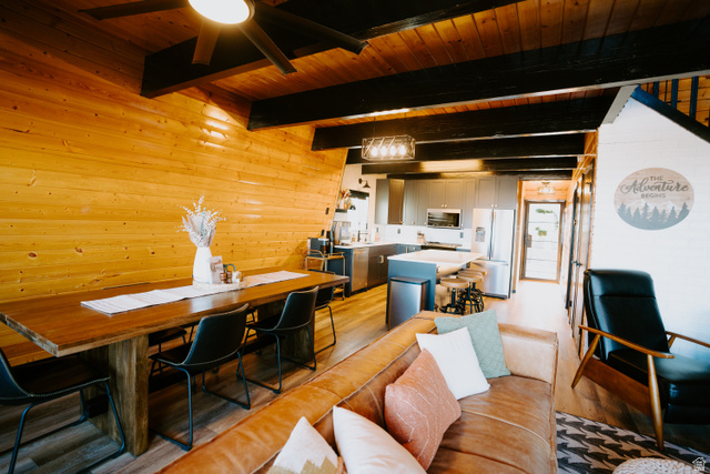 1413 Basel Drive Midway, UT 84049 - Photo 11 of 137 Living area with wooden walls, a wooden ceiling with exposed beams, light wood finished floors, and ceiling fan