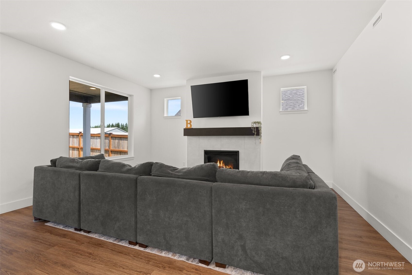 501 Pagget Avenue Winlock, WA 98596 - Photo 7 of 30 a living room with furniture a flat screen tv and a fireplace