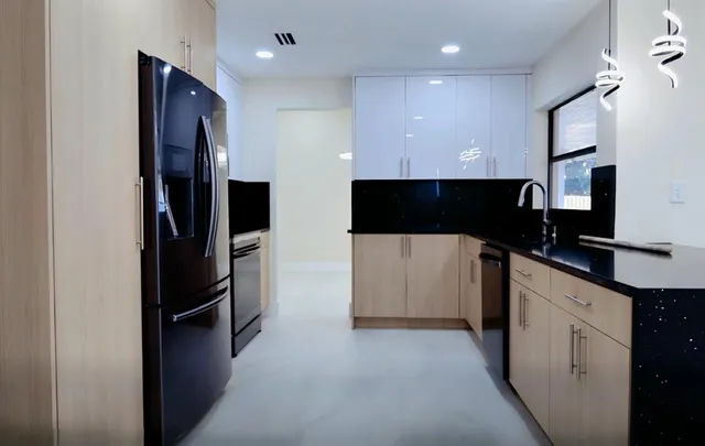 a kitchen with a sink and a refrigerator