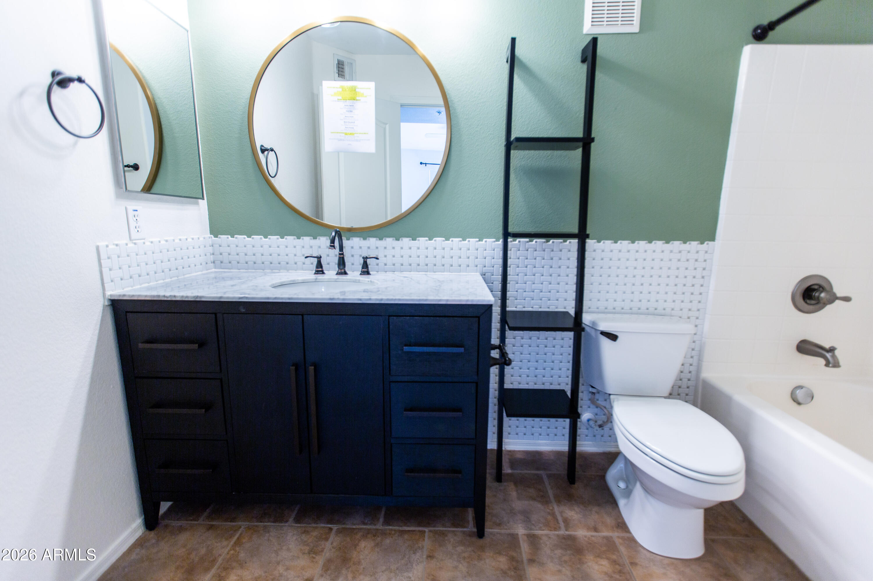 280 South Evergreen Road, Unit 1317 Tempe, AZ 85288 - Photo 4 of 33 a bathroom with a toilet a sink and mirror