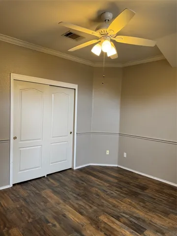 a view of a room with wooden floor