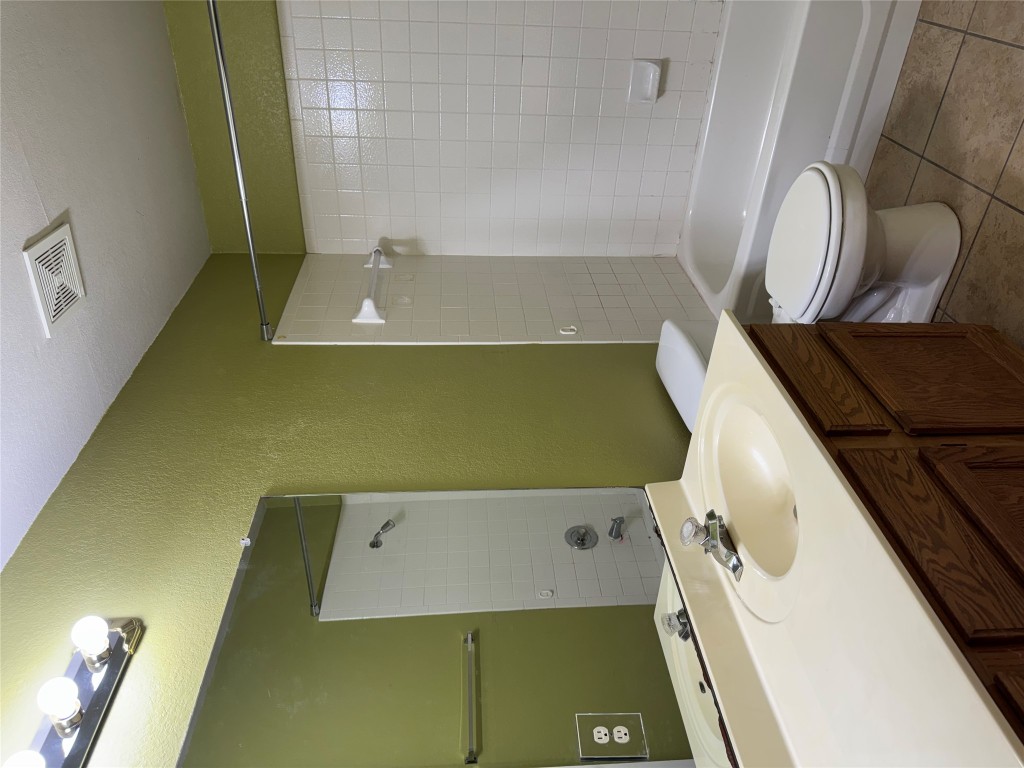 8724 Barrow Glen Loop Austin, TX 78749 - Photo 13 of 19 a bathroom with a sink a toilet and shower