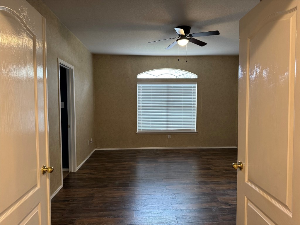 8724 Barrow Glen Loop Austin, TX 78749 - Photo 14 of 19 an empty room with wooden floor and a window