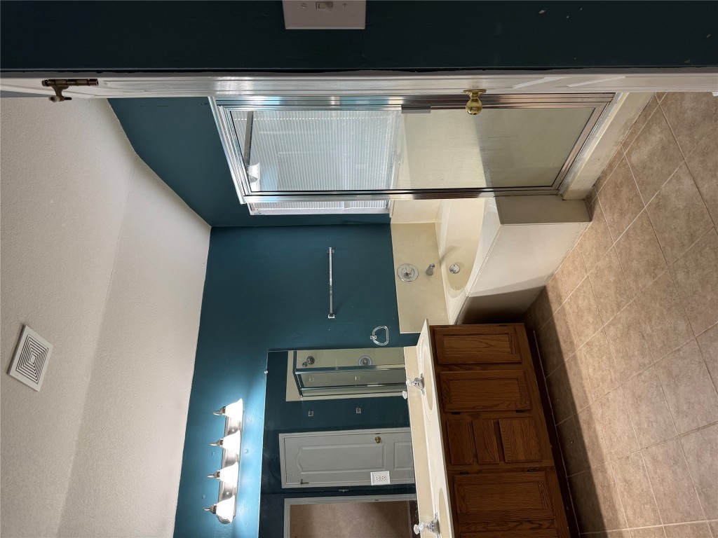 8724 Barrow Glen Loop Austin, TX 78749 - Photo 16 of 19 a spacious bathroom with a tub sink shower and mirror