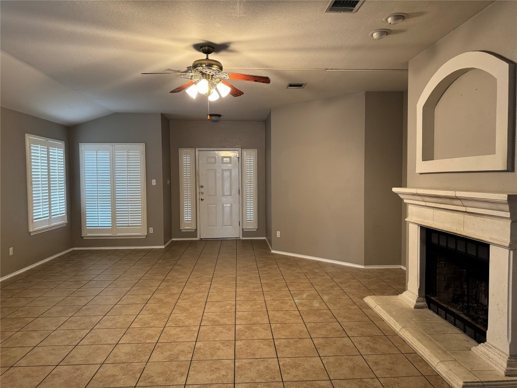 8724 Barrow Glen Loop Austin, TX 78749 - Photo 3 of 19 a view of an empty room with window and chandelier fan