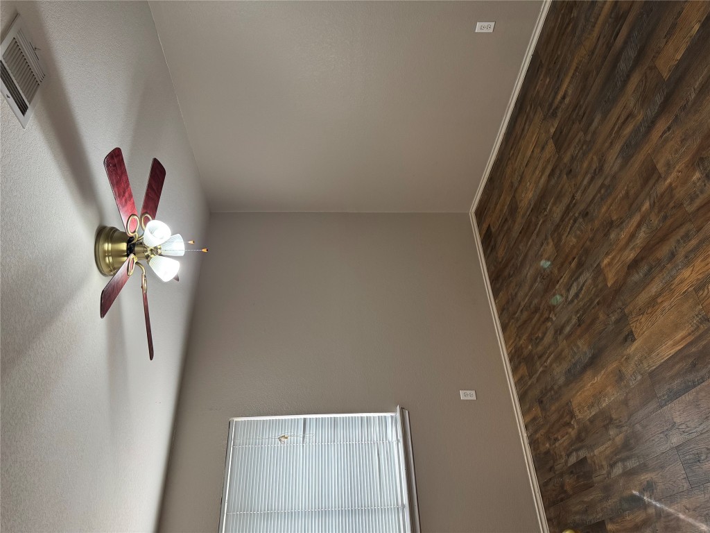 8724 Barrow Glen Loop Austin, TX 78749 - Photo 9 of 19 a view of a room with wooden floor and fan