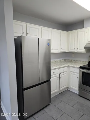 a white refrigerator freezer sitting in a kitchen