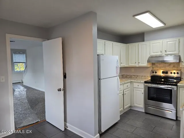 a kitchen with cabinets and stainless steel appliances