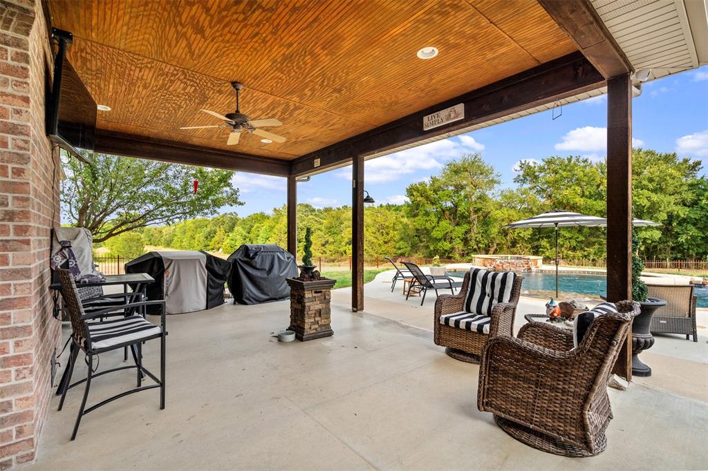 145 County Road 2327 Decatur, TX 76234 - Photo 34 of 40 Spacious covered patio off the living room and kitchen overlooks the beautiful gunite pool and spa.
