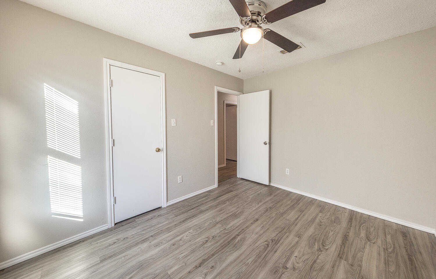 804 East 77th Street Lubbock, TX 79404 - Photo 14 of 15 wooden floor in an empty room with a window