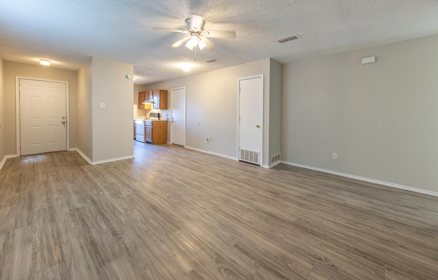 804 East 77th Street Lubbock, TX 79404 - Photo 2 of 15 an empty room with wooden floor and windows
