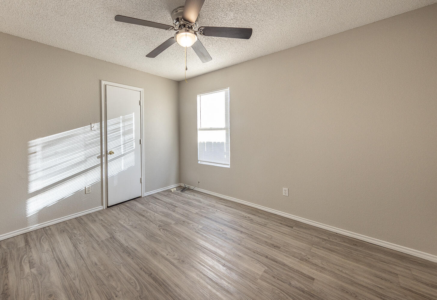 804 East 77th Street Lubbock, TX 79404 - Photo 7 of 15 wooden floor in an empty room with a window