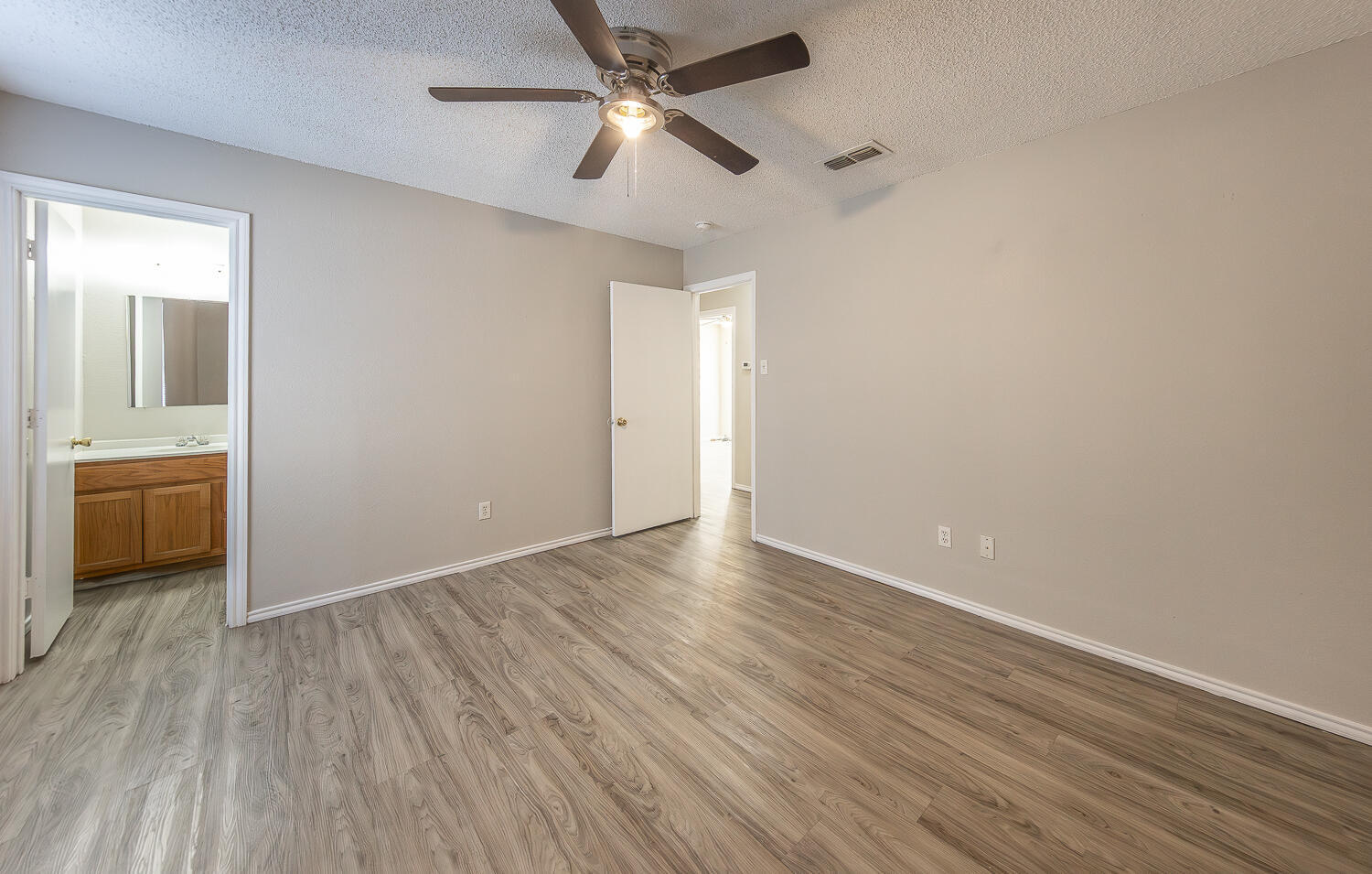 804 East 77th Street Lubbock, TX 79404 - Photo 10 of 15 an empty room with wooden floor a ceiling fan and closet