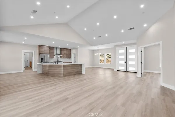 a kitchen with stainless steel appliances kitchen island granite countertop a stove and a sink
