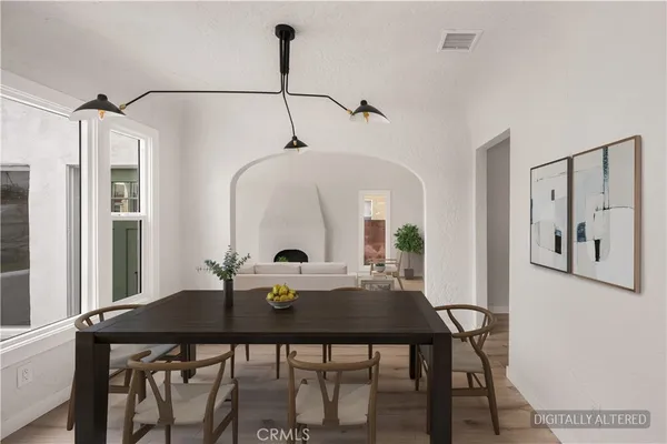 a view of a dining room with a table and chairs