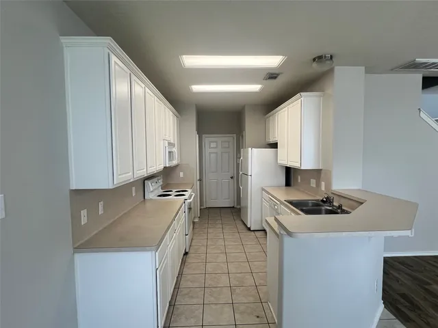 a kitchen with stainless steel appliances a sink stove and cabinets