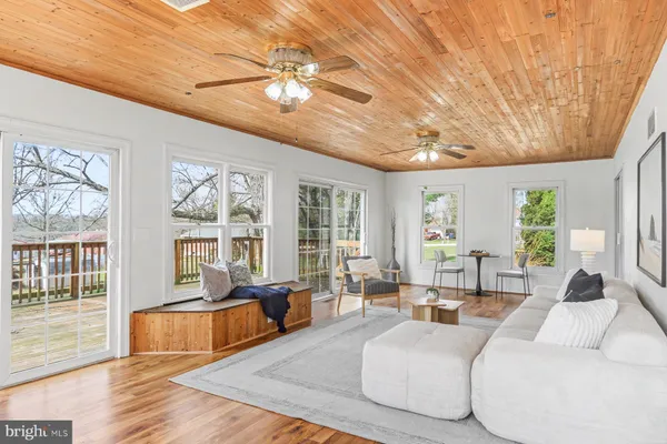 a living room with furniture and large windows