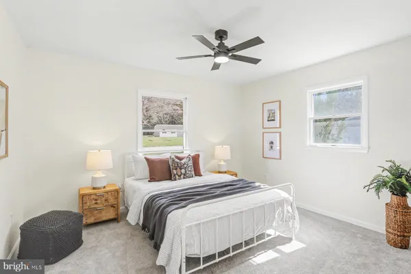 a bedroom with a bed and a potted plant