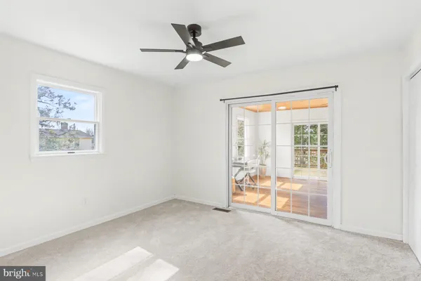 a view of a livingroom with a ceiling fan and window