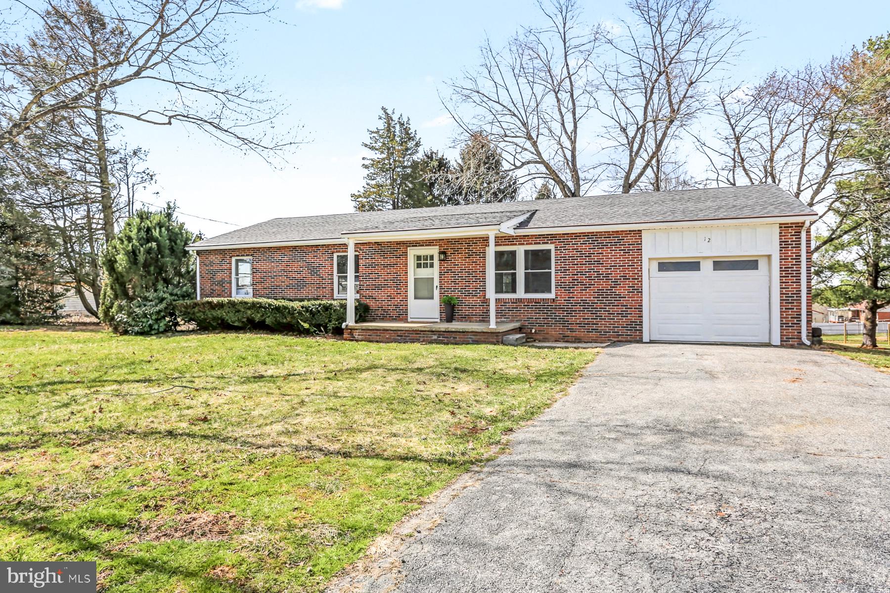 12 Locust Street Stewartstown, PA 17363 - Photo 2 of 23 a front view of a house with a garden