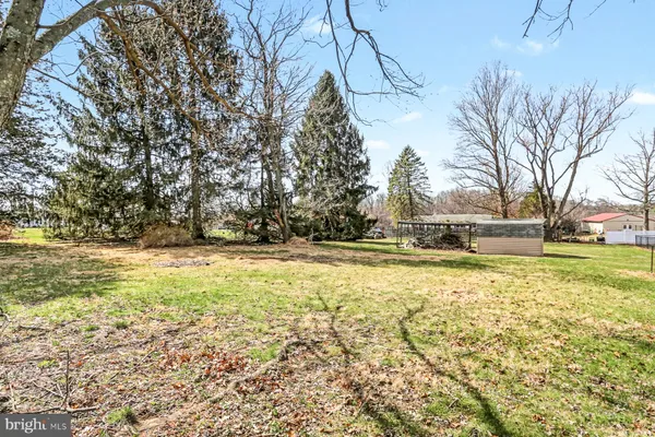 a view of yard with swimming pool and trees