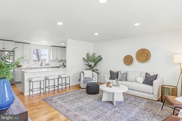 a living room with furniture and kitchen view