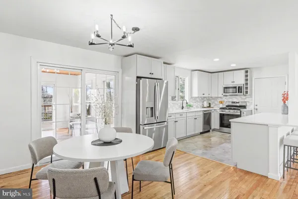 a kitchen with refrigerator cabinets dining table and chairs