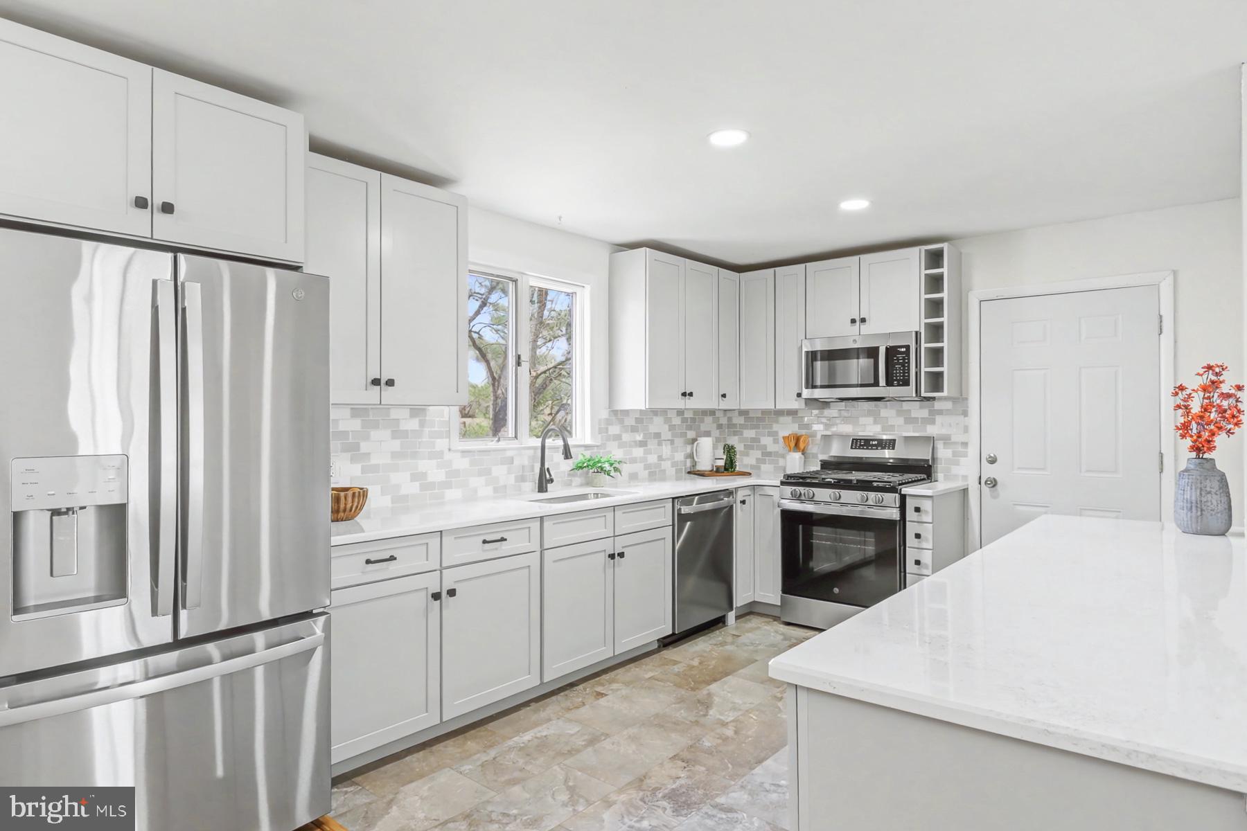 12 Locust Street Stewartstown, PA 17363 - Photo 5 of 23 a kitchen with stainless steel appliances granite countertop a refrigerator sink and stove