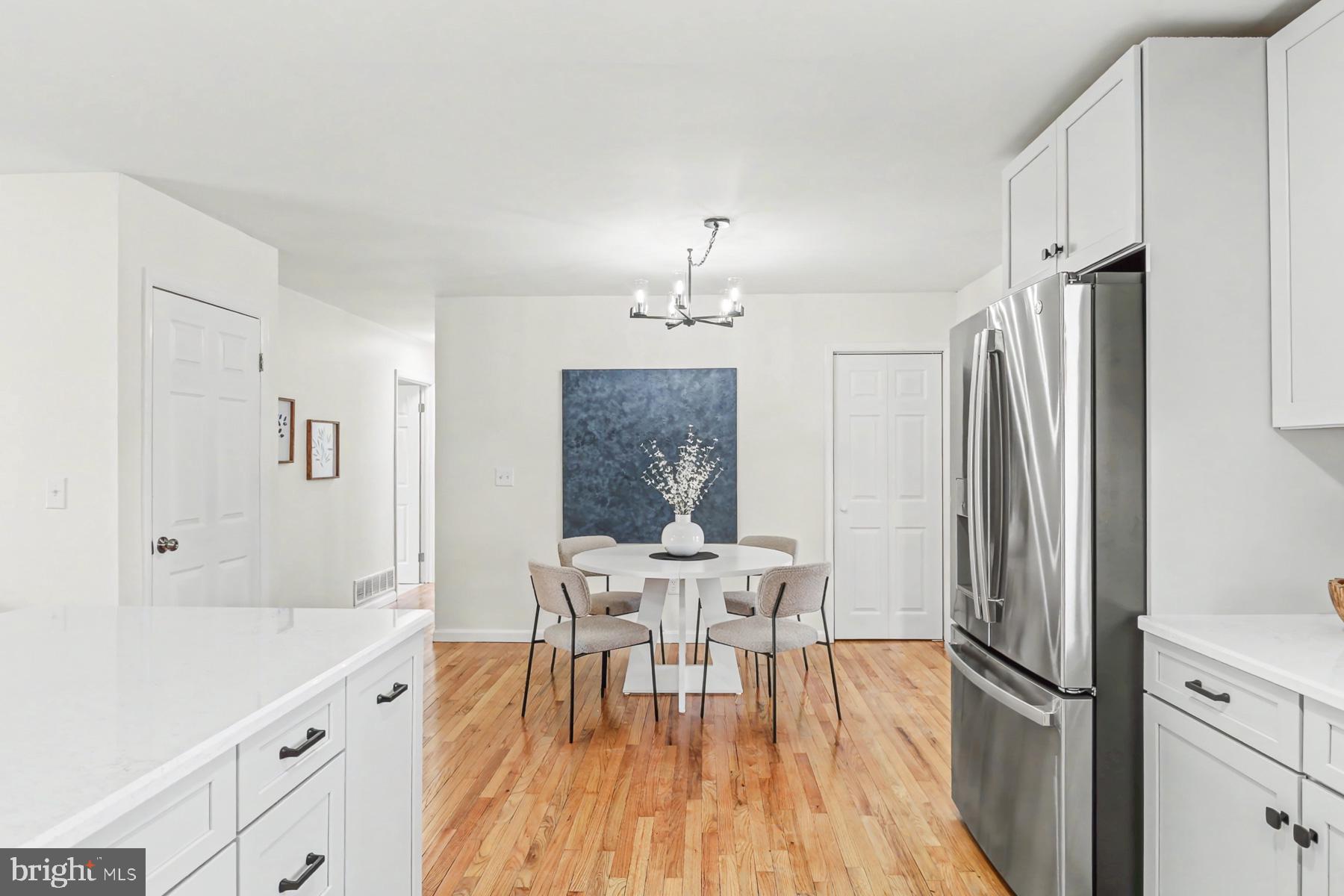 12 Locust Street Stewartstown, PA 17363 - Photo 6 of 23 a kitchen with stainless steel appliances a dining table chairs and chandelier
