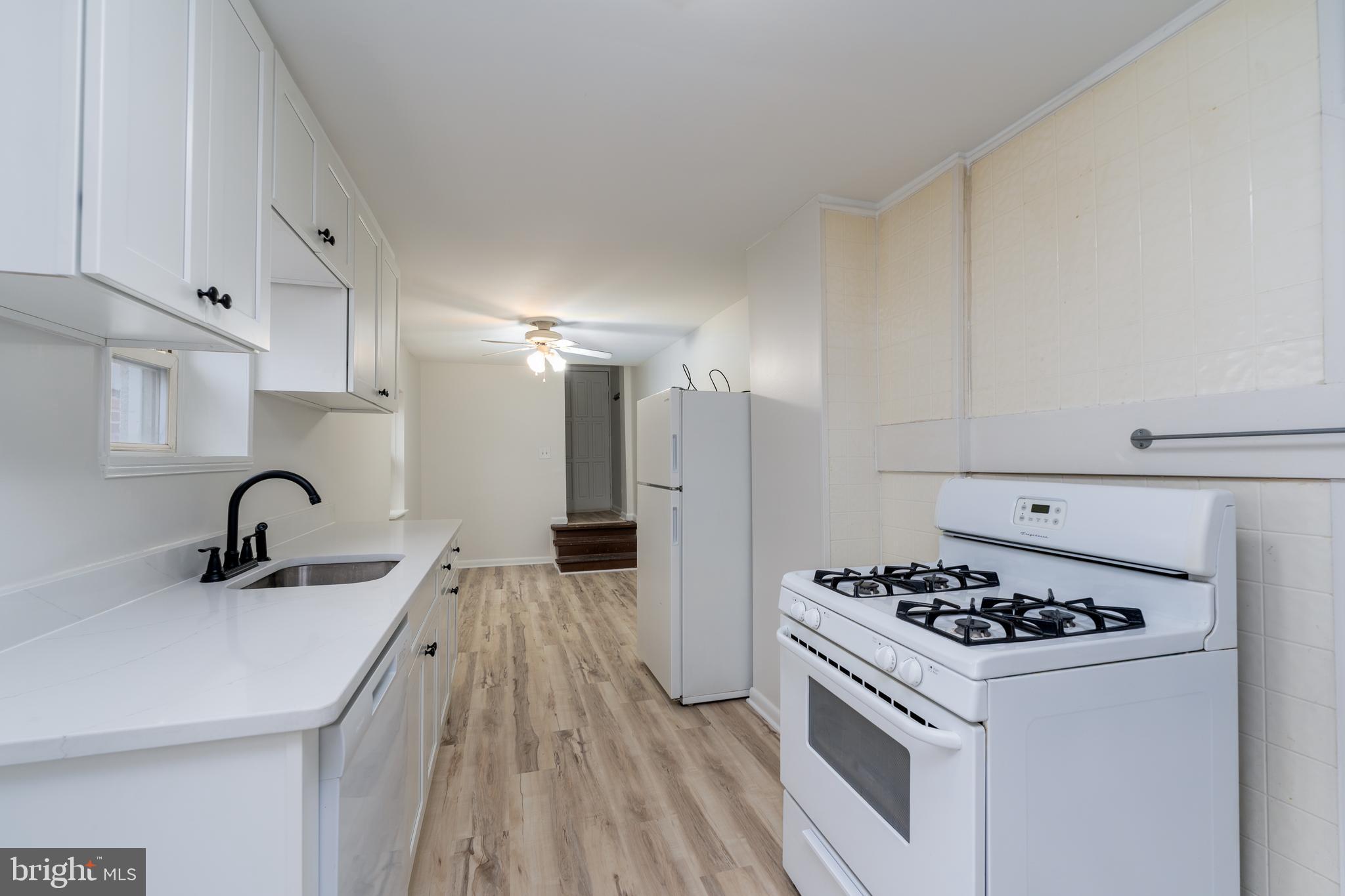 1722 Eastern Avenue, Unit 3 Baltimore, MD 21231 - Photo 2 of 13 a kitchen with a sink a stove and refrigerator