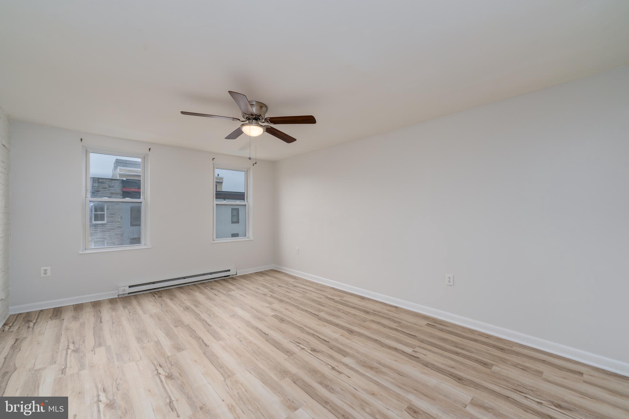 1722 Eastern Avenue, Unit 3 Baltimore, MD 21231 - Photo 9 of 13 wooden floor in an empty room with a window