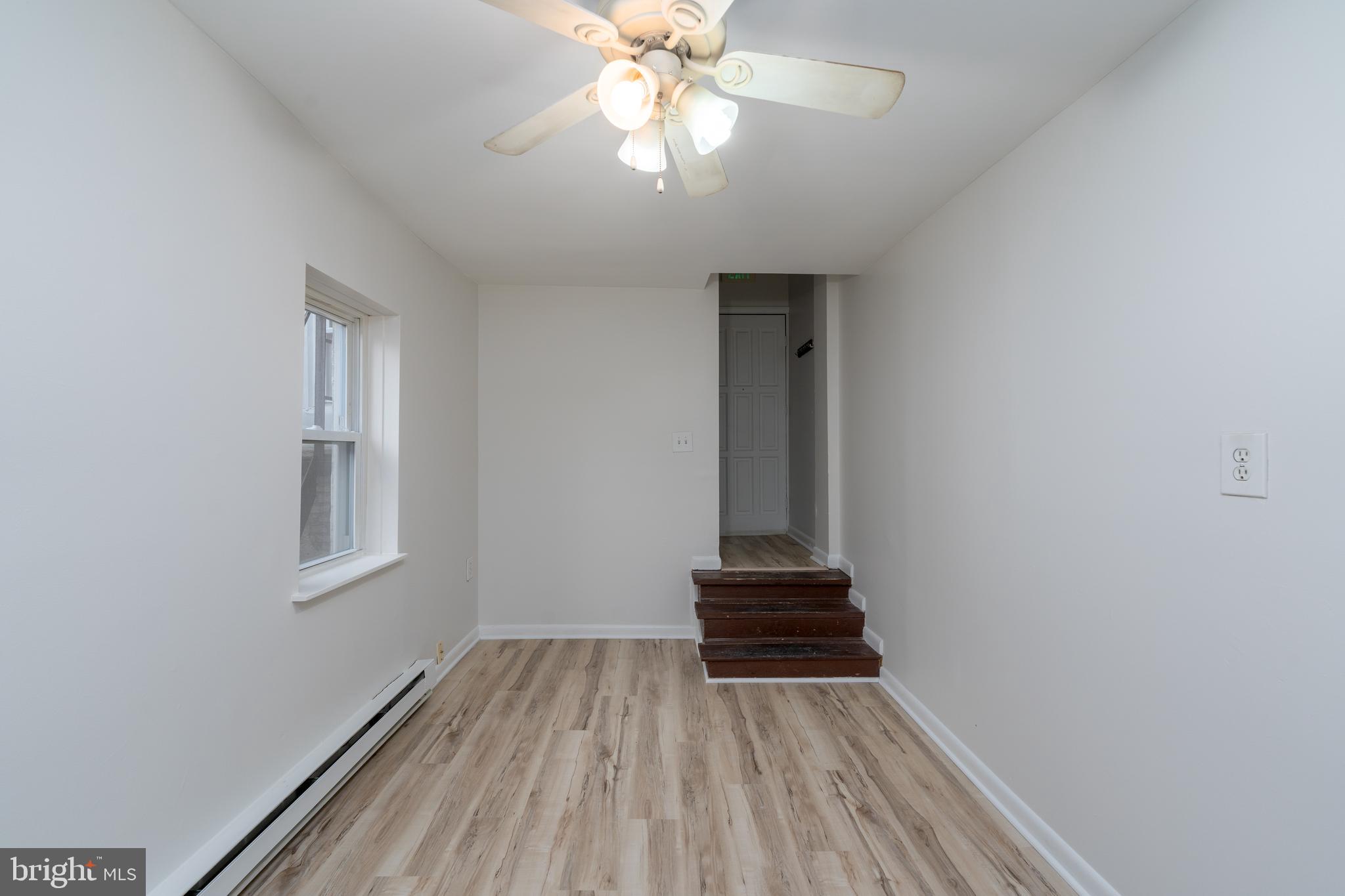 1722 Eastern Avenue, Unit 3 Baltimore, MD 21231 - Photo 10 of 13 wooden floor in an empty room with a window