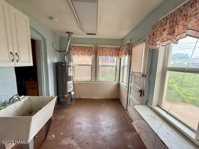a view of hallway with furniture and a large window