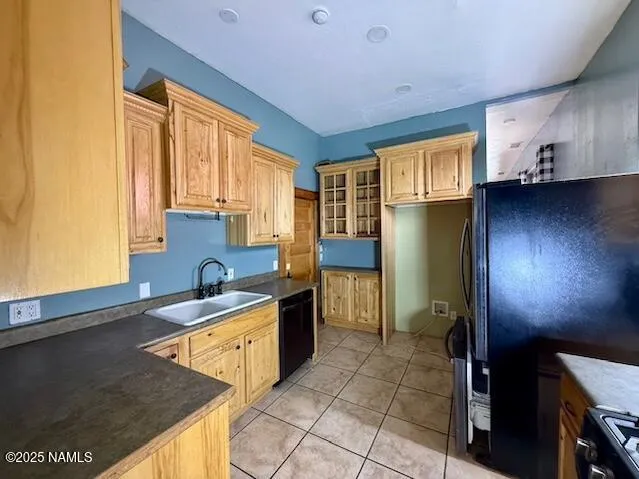 a kitchen with a sink a stove and cabinets