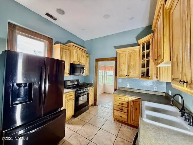 a kitchen with stainless steel appliances granite countertop a refrigerator and a stove