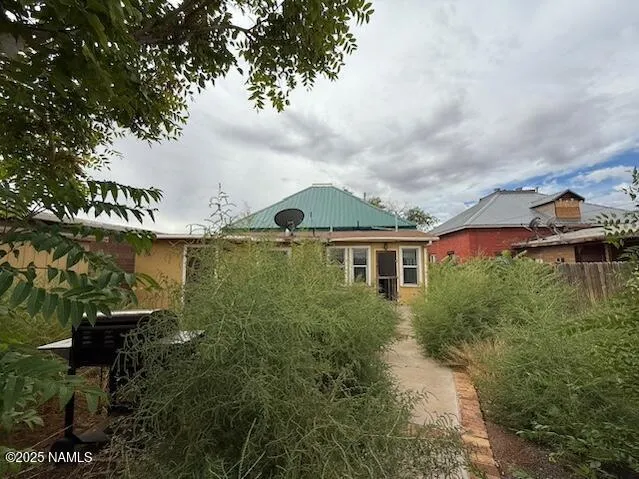 a view of a house with a yard and sitting area
