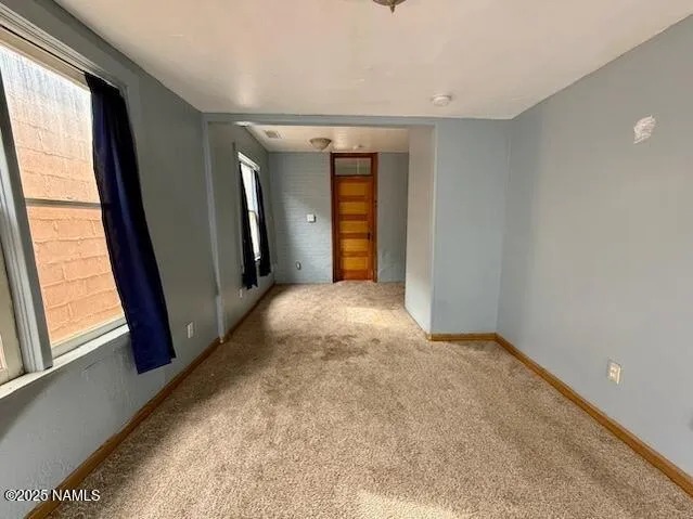 a view of hallway with furniture and a window