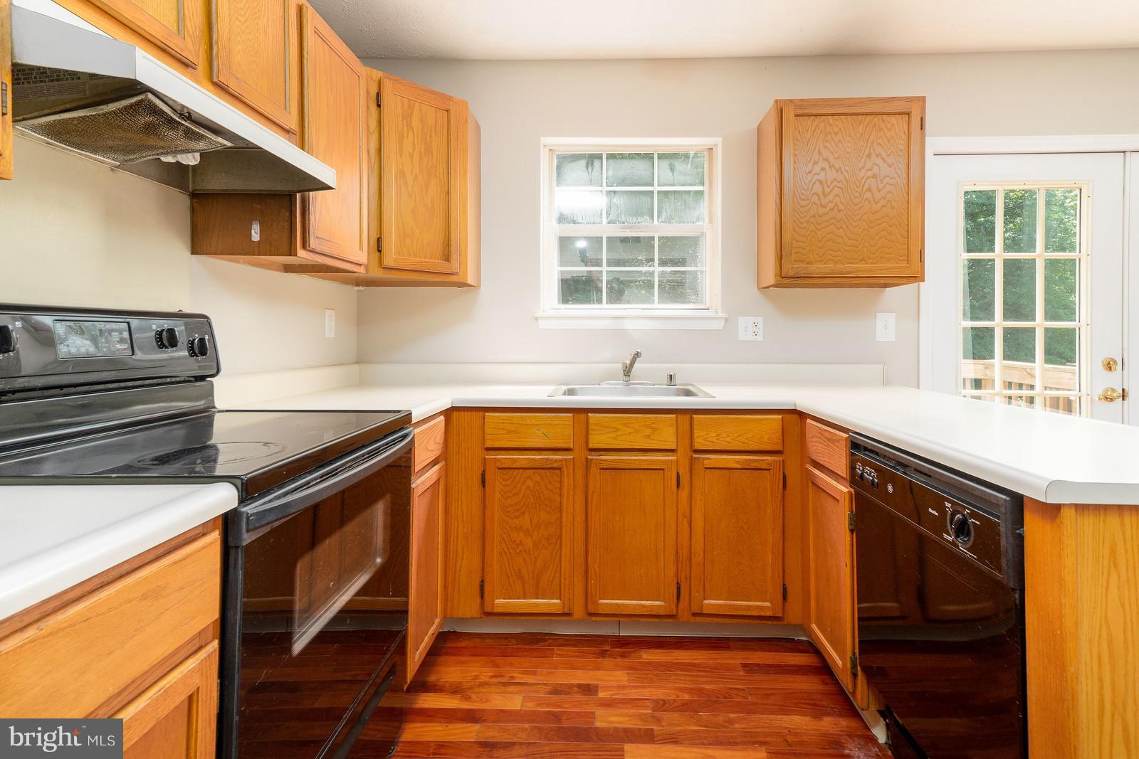 4083 Rustico Road Baltimore, MD 21220 - Photo 11 of 25 a kitchen with stainless steel appliances granite countertop a sink stove and cabinets