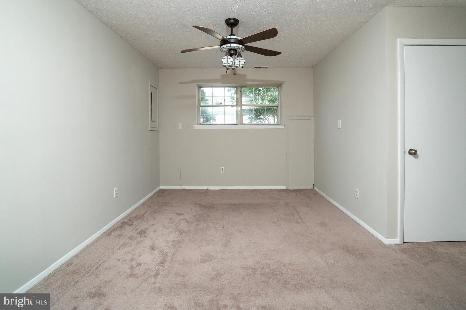 4083 Rustico Road Baltimore, MD 21220 - Photo 20 of 25 an empty room with a window and a fan