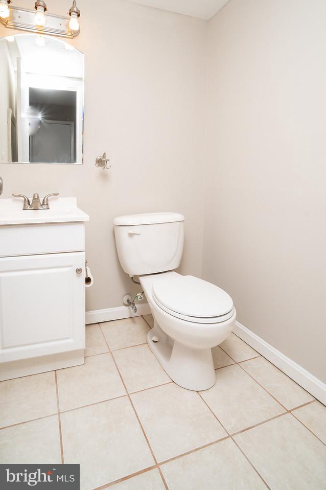 4083 Rustico Road Baltimore, MD 21220 - Photo 25 of 25 a bathroom with a toilet a sink and a mirror
