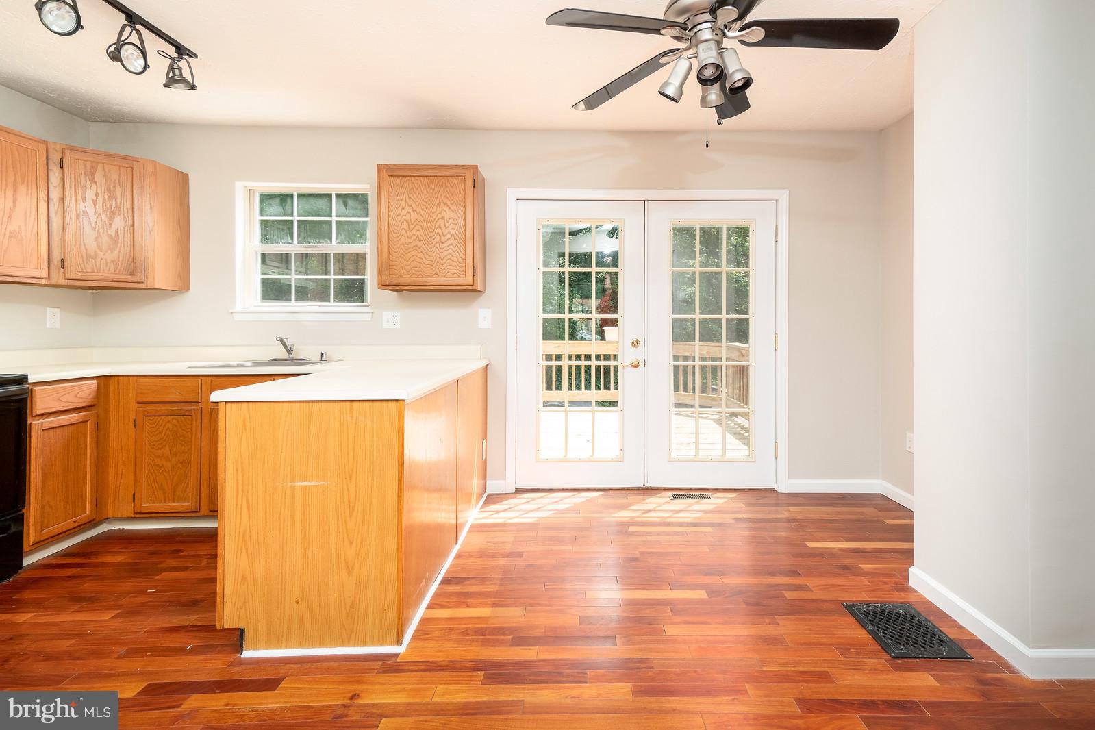 4083 Rustico Road Baltimore, MD 21220 - Photo 8 of 25 a view of a kitchen with a sink hardwood floor and a window