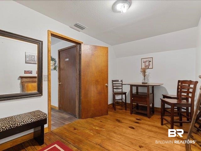 4650 Wiggins Lane Wilmer, AL 36587 - Photo 49 of 66 Sitting room featuring lofted ceiling and wood finished floors