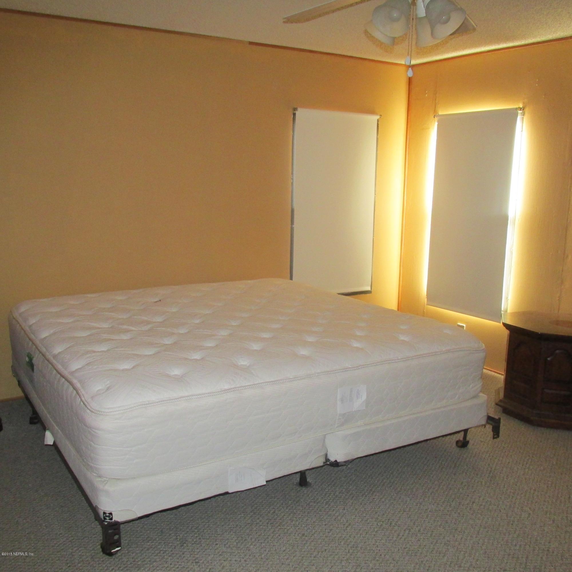 6841 Deer Springs Road Keystone Heights, FL 32656 - Photo 11 of 27 a bed sitting in a bedroom next to a window
