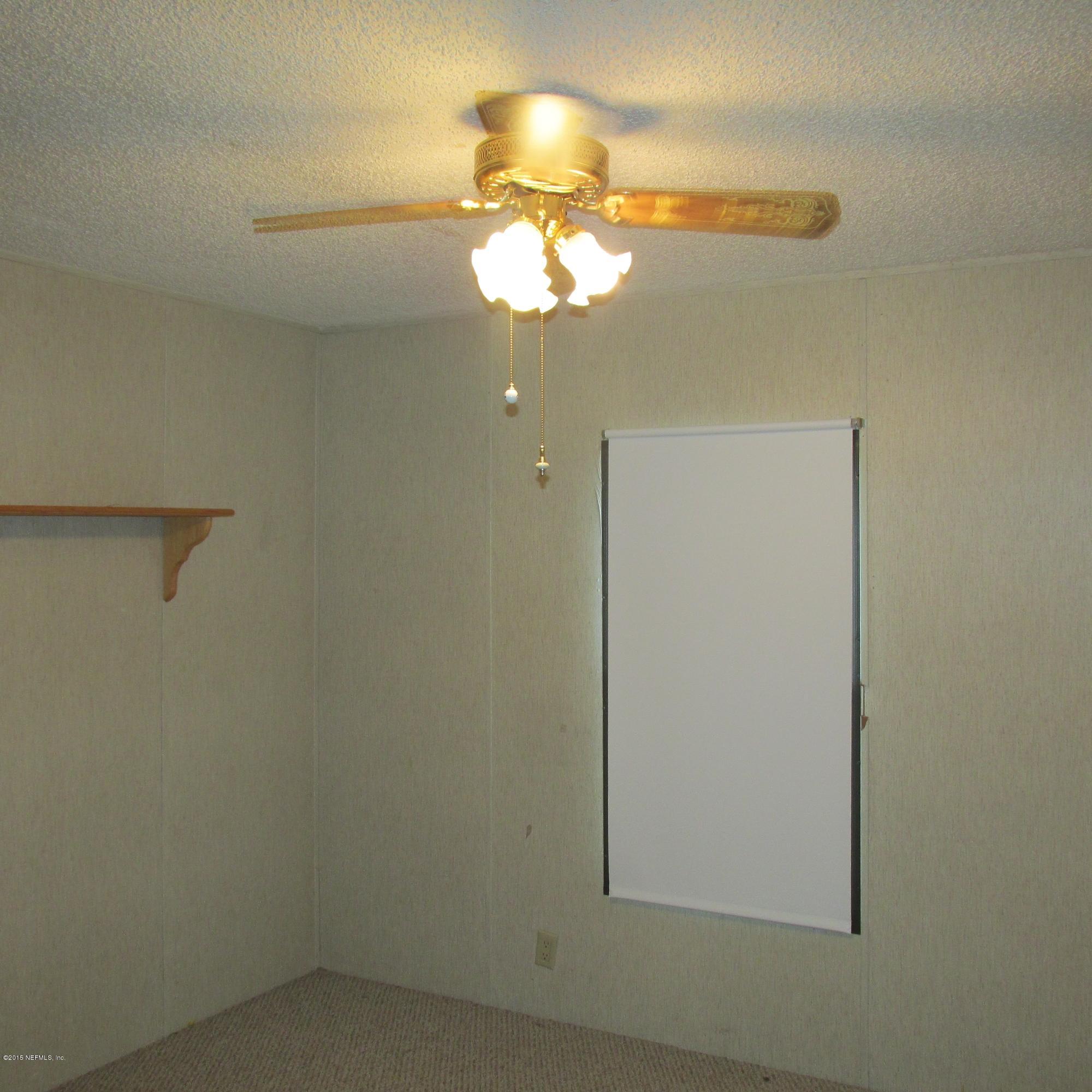 6841 Deer Springs Road Keystone Heights, FL 32656 - Photo 17 of 27 a view of a livingroom with a fan