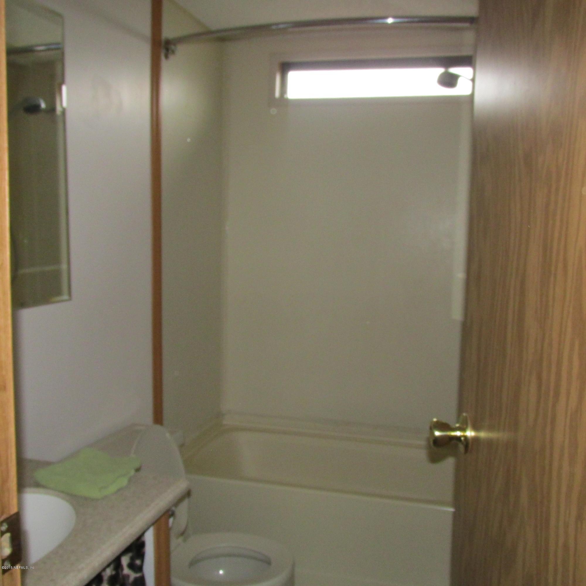 6841 Deer Springs Road Keystone Heights, FL 32656 - Photo 19 of 27 a bathroom with a sink and a mirror