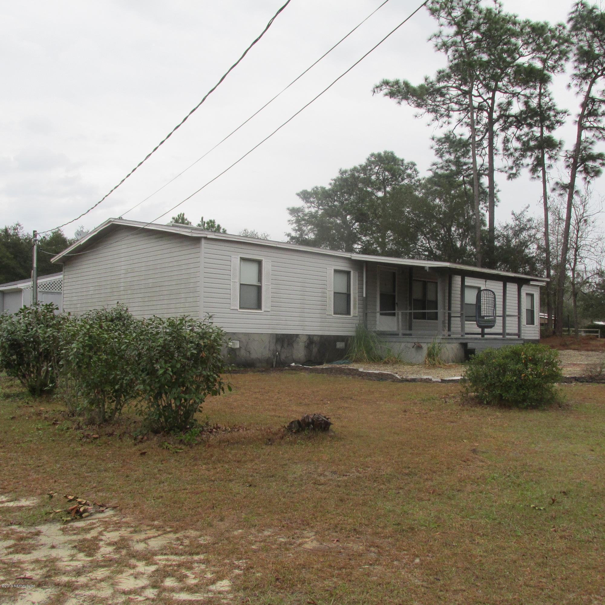 6841 Deer Springs Road Keystone Heights, FL 32656 - Photo 2 of 27 a backyard of a house with plants and trees